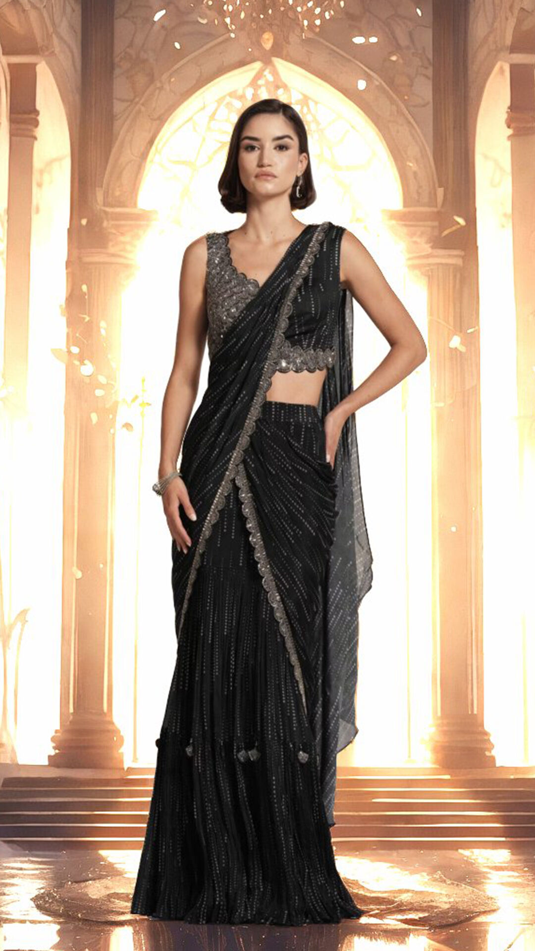Woman modeling a pre-draped black designer saree with a sequined sleeveless blouse, showcasing a monochromatic modern style.